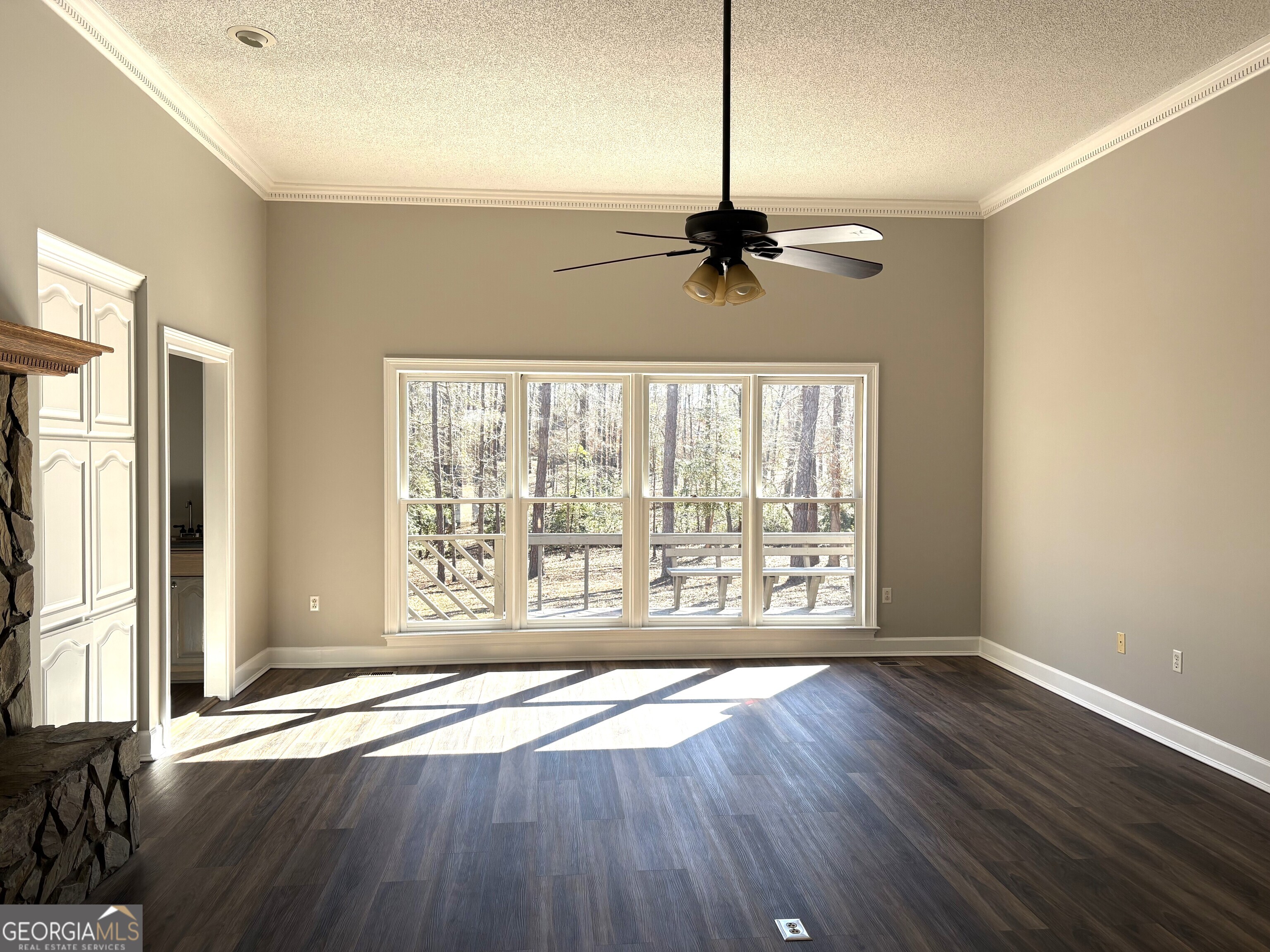 245 Woodland Street Dublin, GA 31021 - Photo 14 of 48 a view of an empty room with wooden floor and a window