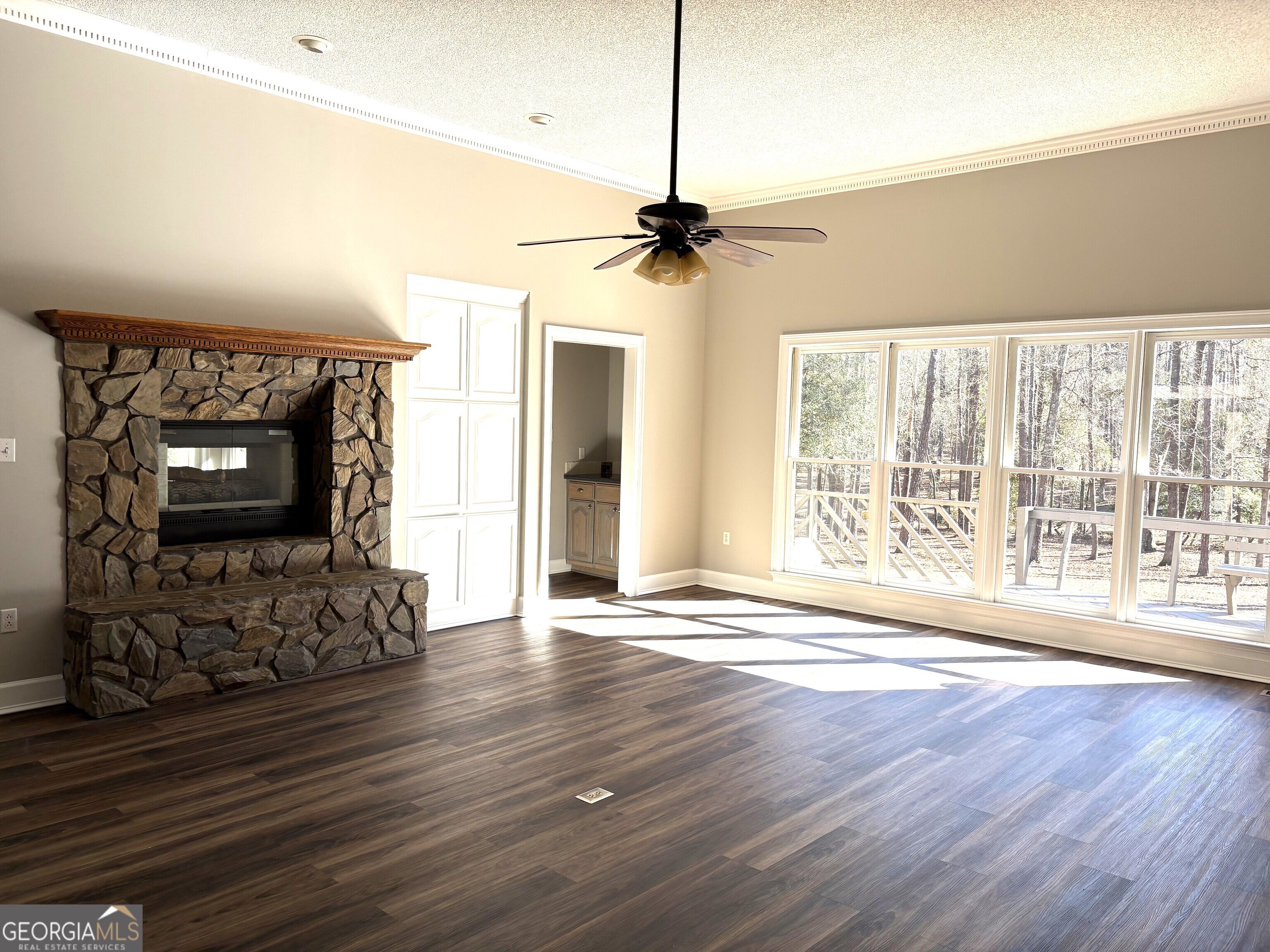 245 Woodland Street Dublin, GA 31021 - Photo 15 of 48 a view of empty room with wooden floor fireplace and a window