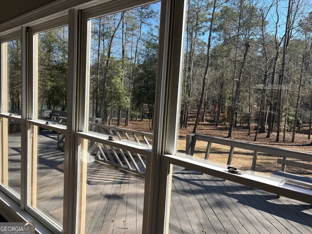 a view of a balcony with floor to ceiling windows