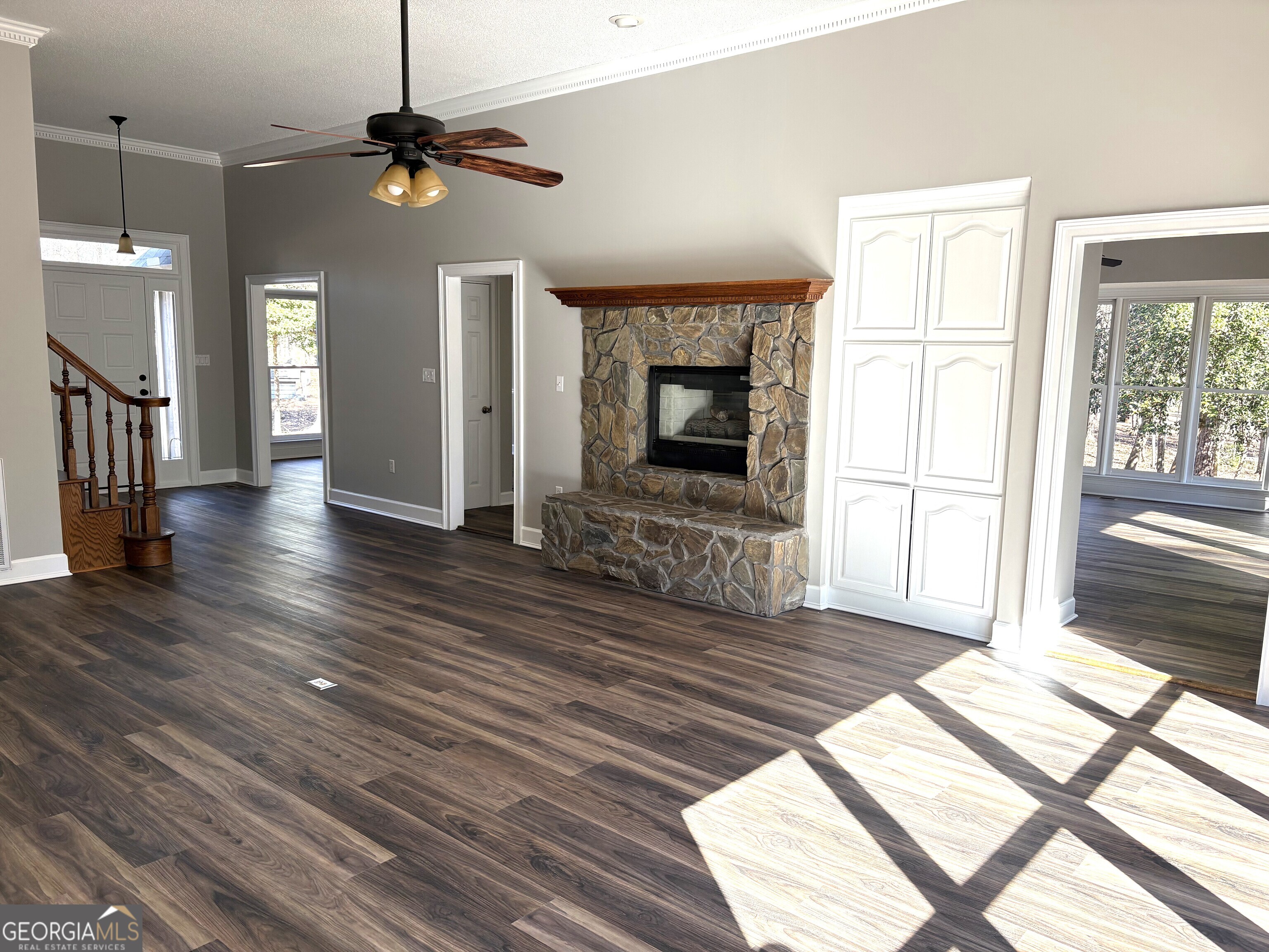 245 Woodland Street Dublin, GA 31021 - Photo 17 of 48 a view of an empty room with wooden floor fireplace and a window