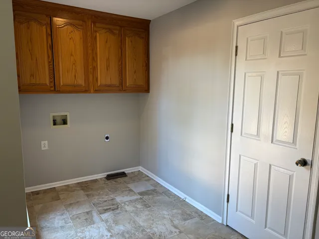 a view of storage and utility room with wooden floor