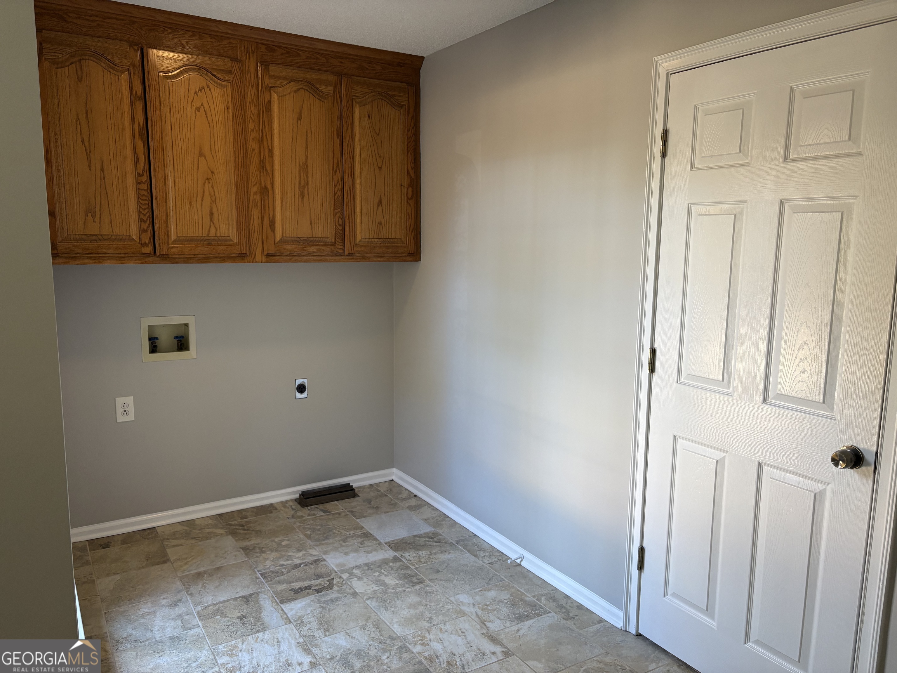 245 Woodland Street Dublin, GA 31021 - Photo 19 of 48 a view of storage and utility room with wooden floor