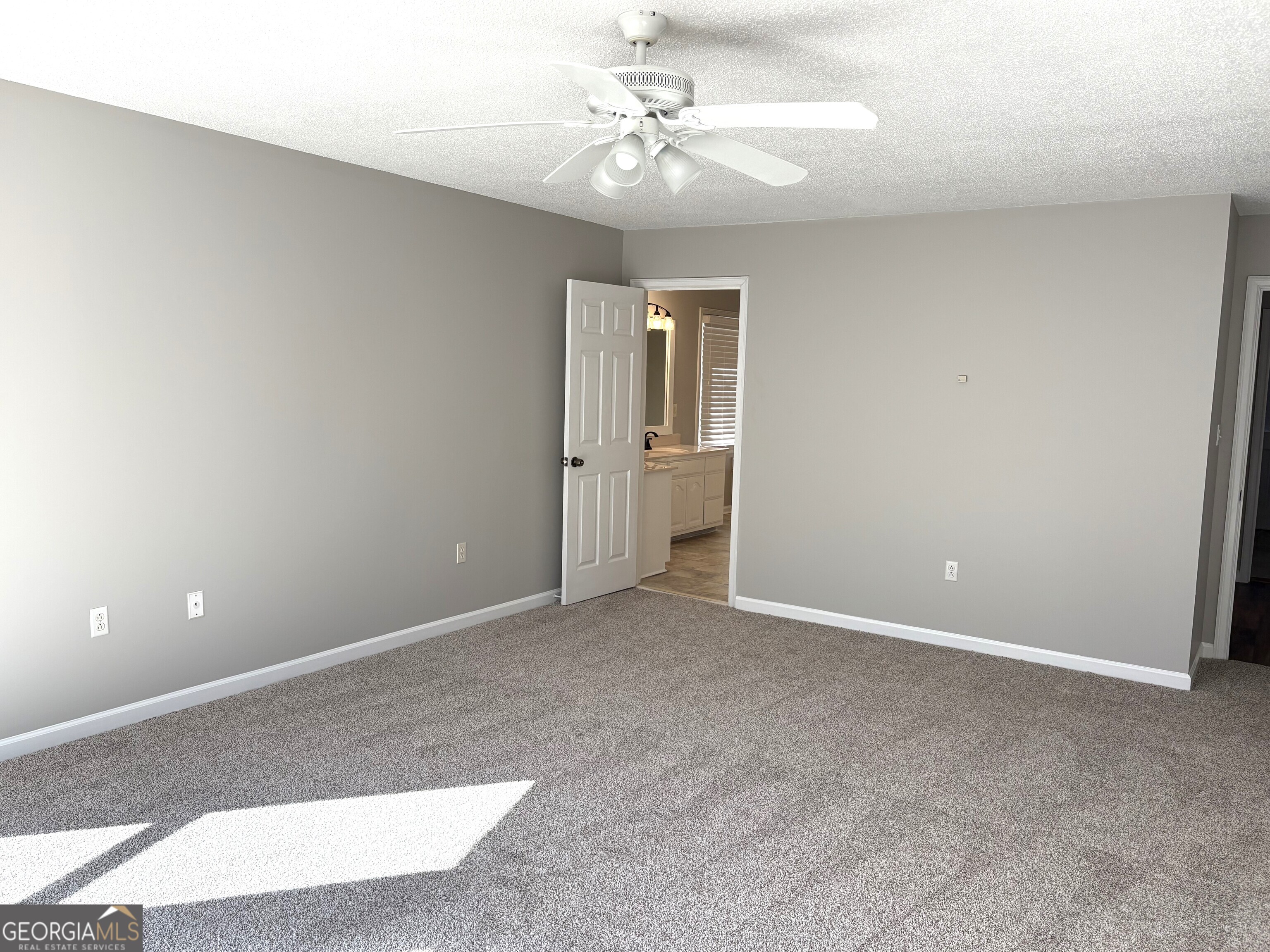 245 Woodland Street Dublin, GA 31021 - Photo 22 of 48 an empty room with chandelier fan and windows