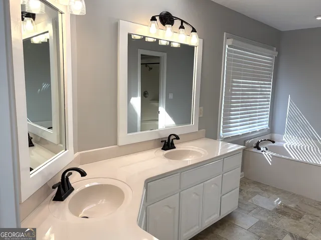 a bathroom with a bathtub and a shower