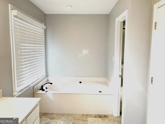 a white toilet sitting next to a bath tub