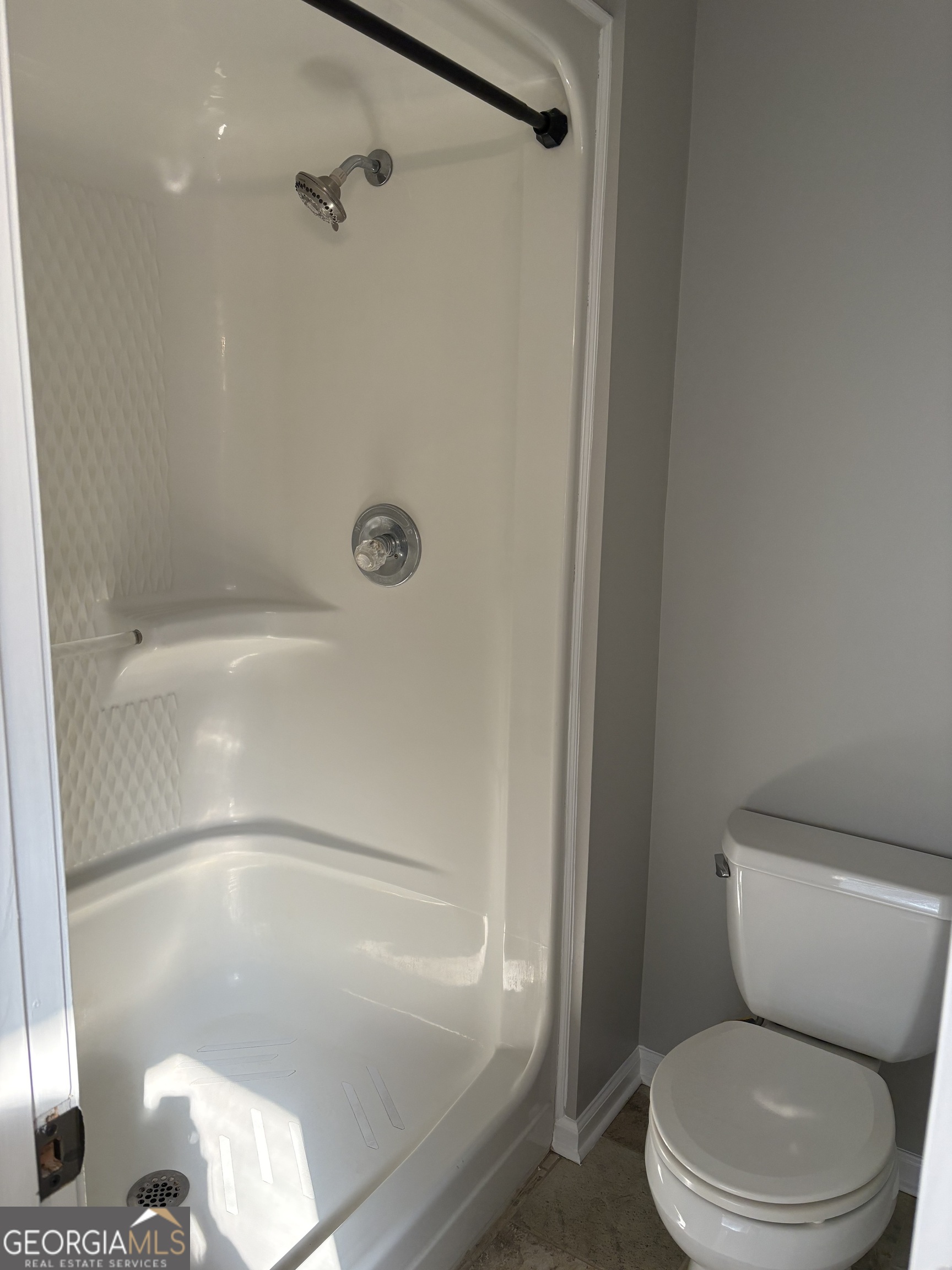 245 Woodland Street Dublin, GA 31021 - Photo 25 of 48 a white toilet sitting next to a bath tub