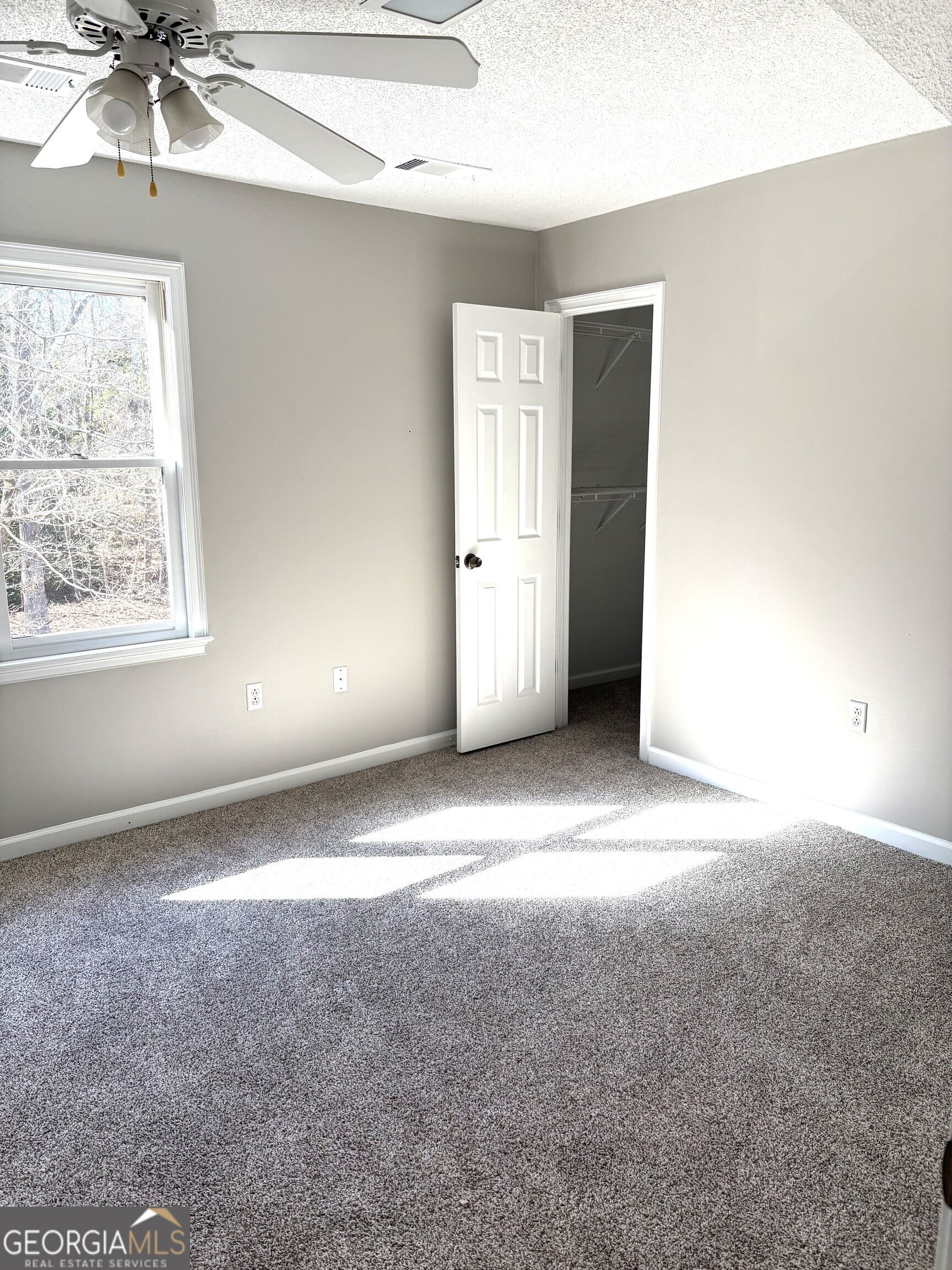 245 Woodland Street Dublin, GA 31021 - Photo 29 of 48 an empty room with windows and fan