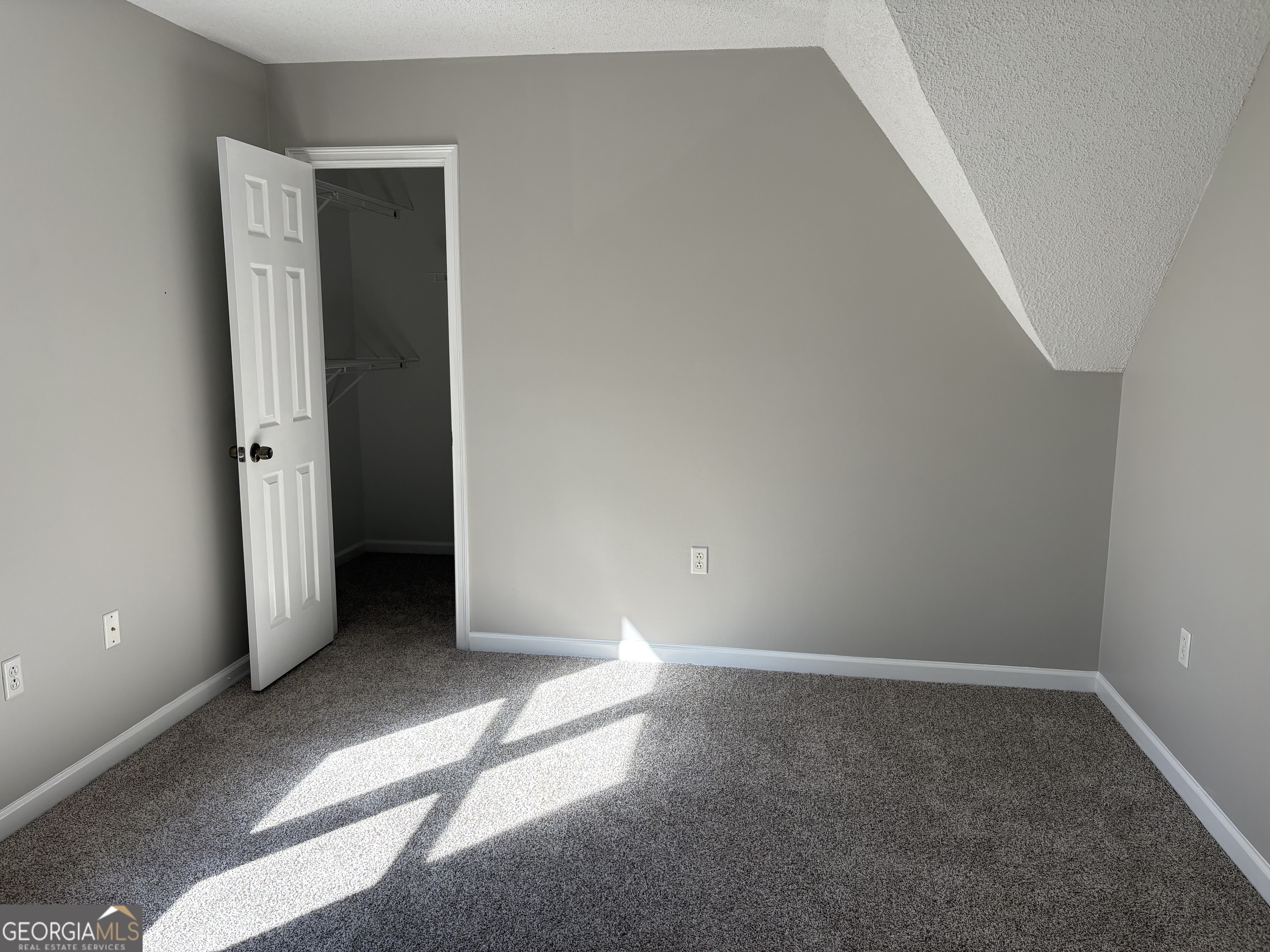 245 Woodland Street Dublin, GA 31021 - Photo 35 of 48 an empty room with windows and entrance to other room