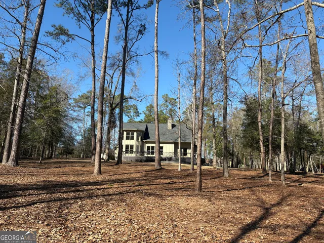a view of a yard with wooden fence