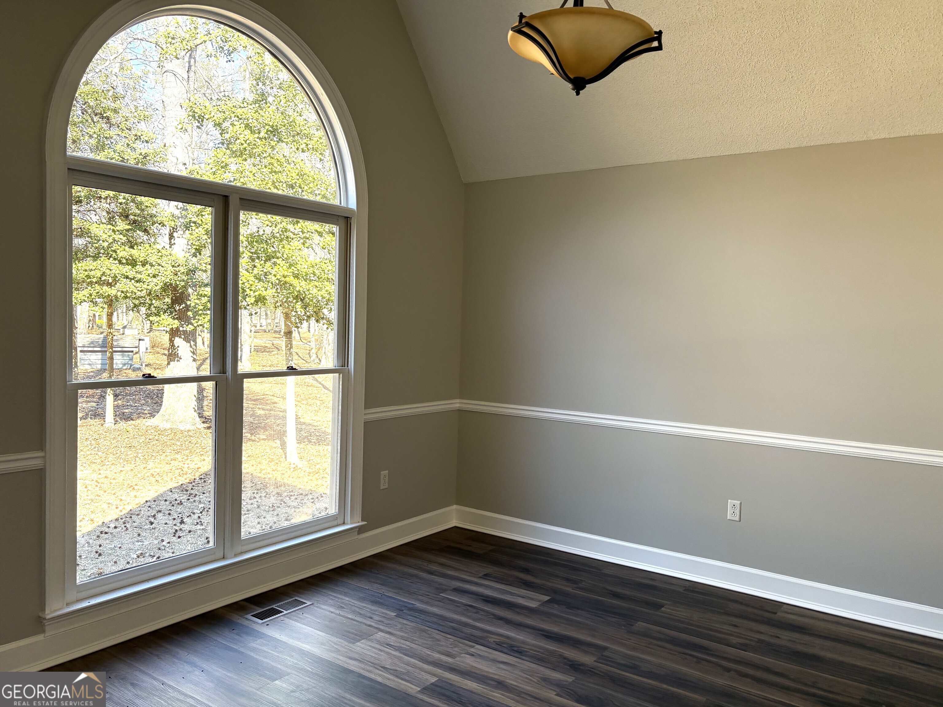 245 Woodland Street Dublin, GA 31021 - Photo 5 of 48 an empty room with wooden floor and windows