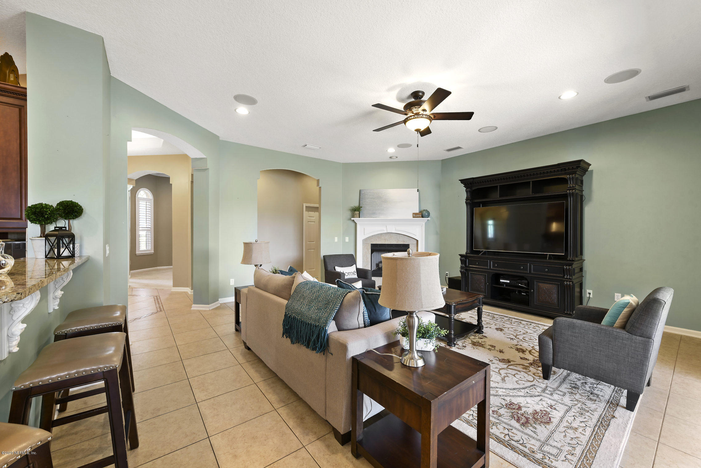 537 Saddlestone Drive St. Johns, FL 32259 - Photo 20 of 50 a living room with furniture a flat screen tv and kitchen view