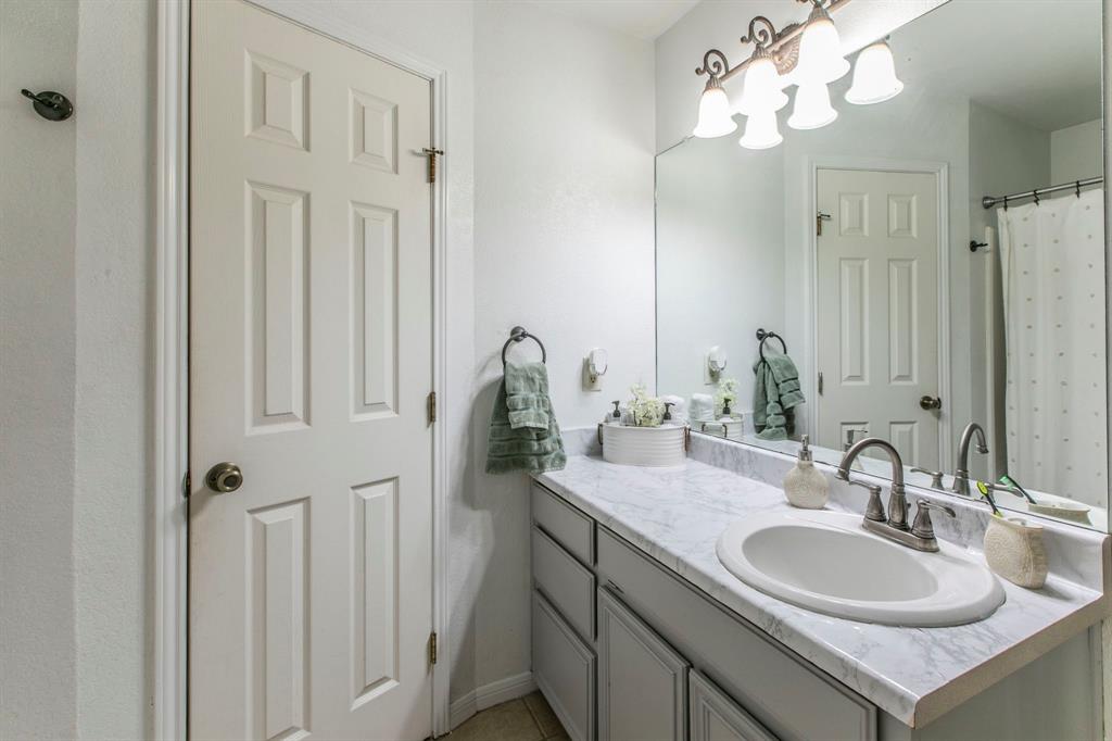 1815 Riata Drive Woodway, TX 76712 - Photo 12 of 25 a bathroom with a sink vanity and a mirror