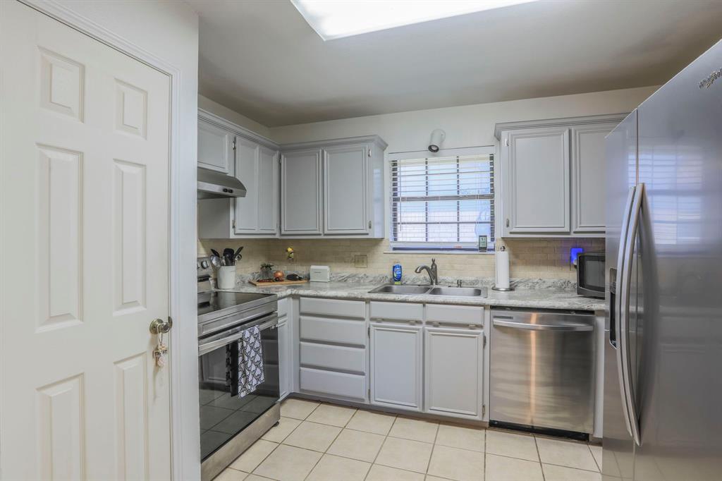 1815 Riata Drive Woodway, TX 76712 - Photo 4 of 25 a kitchen with a stove sink and refrigerator