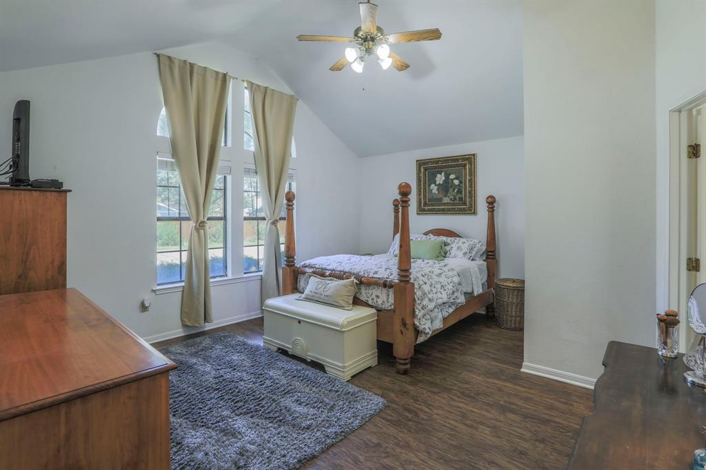 1815 Riata Drive Woodway, TX 76712 - Photo 5 of 25 a spacious bedroom with a bed window and couch