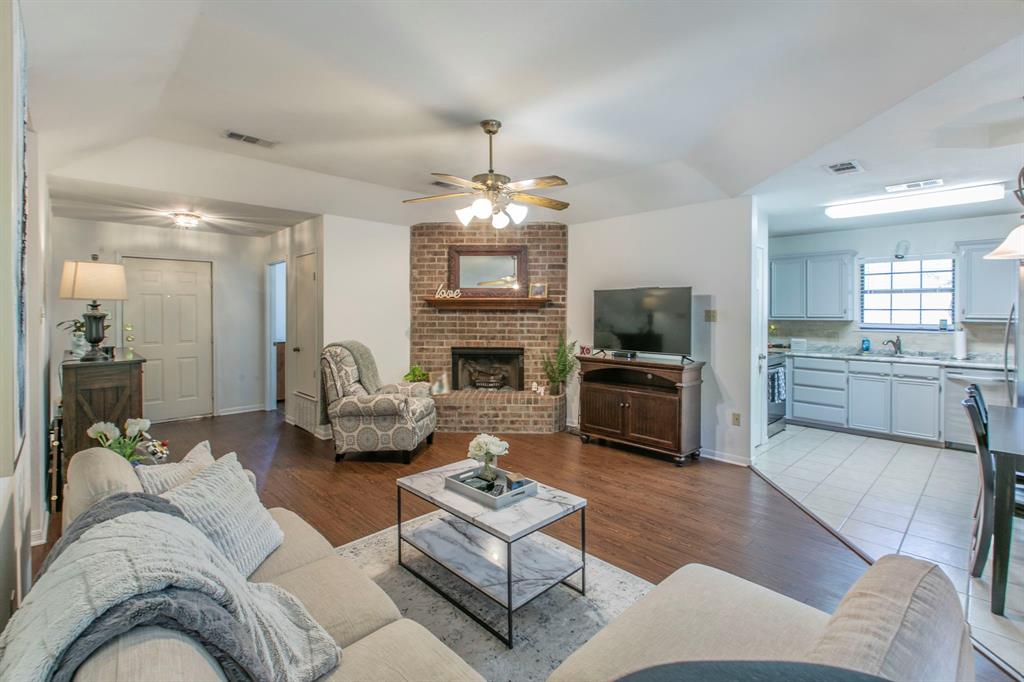 1815 Riata Drive Woodway, TX 76712 - Photo 7 of 25 a living room with furniture kitchen view and a fireplace