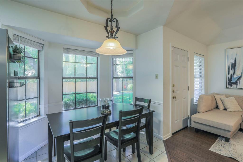 1815 Riata Drive Woodway, TX 76712 - Photo 8 of 25 a dining room with furniture a chandelier and wooden floor