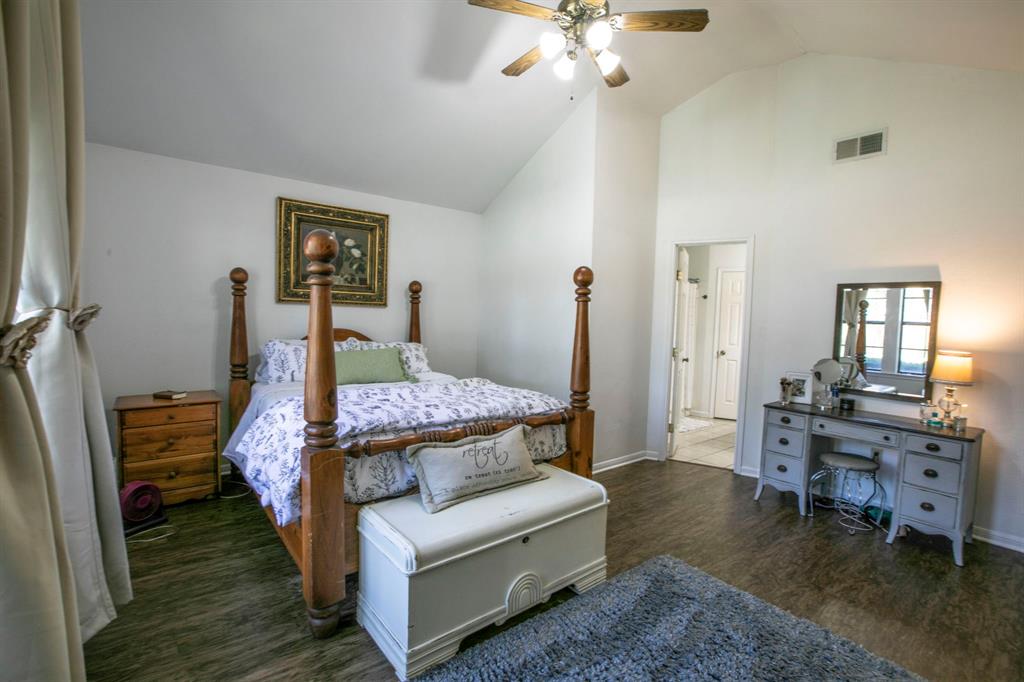 1815 Riata Drive Woodway, TX 76712 - Photo 9 of 25 a bedroom with a bed and wooden floor