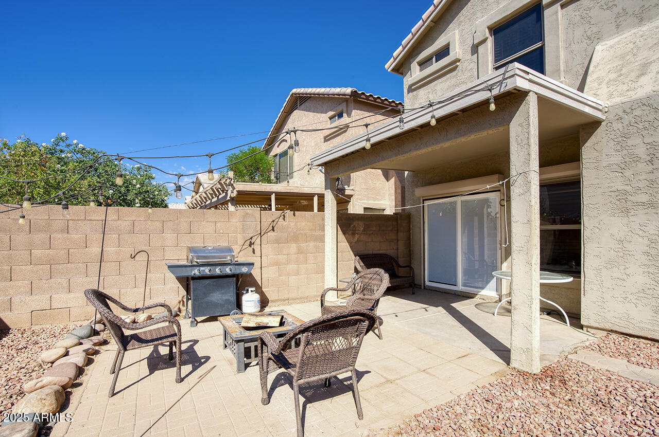 10617 West Coronado Road Avondale, AZ 85392 - Photo 20 of 32 a view of a patio with table and chairs with wooden floor and fence
