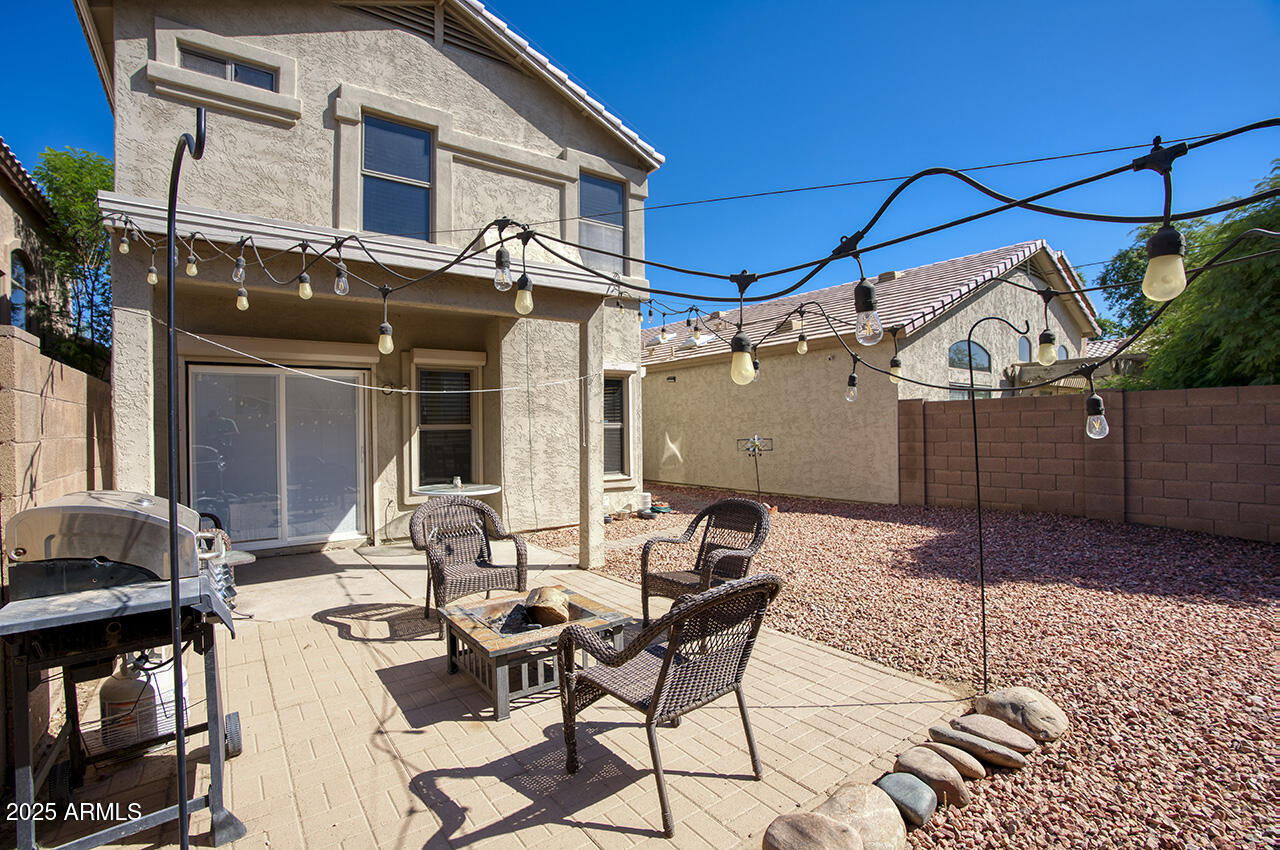 10617 West Coronado Road Avondale, AZ 85392 - Photo 21 of 32 a view of a patio with table and chairs and barbeque