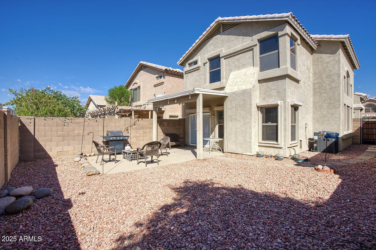 10617 West Coronado Road Avondale, AZ 85392 - Photo 22 of 32 a view of a white house with wooden fence
