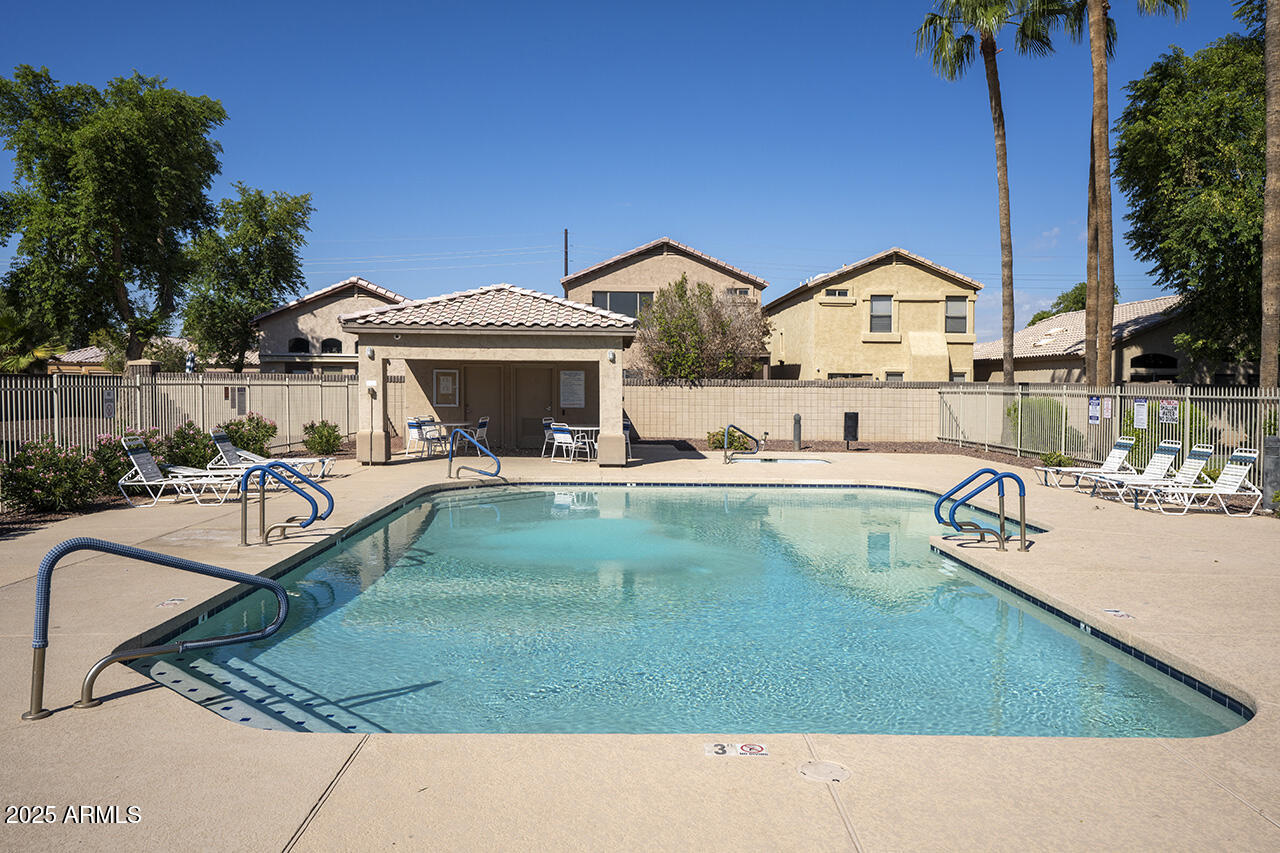 10617 West Coronado Road Avondale, AZ 85392 - Photo 25 of 32 a view of a house with swimming pool and a yard