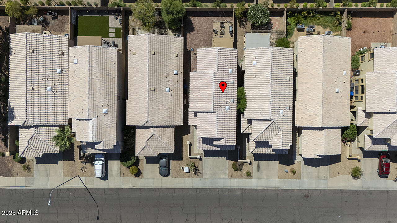 10617 West Coronado Road Avondale, AZ 85392 - Photo 29 of 32 an aerial view of residential houses with outdoor space and parking