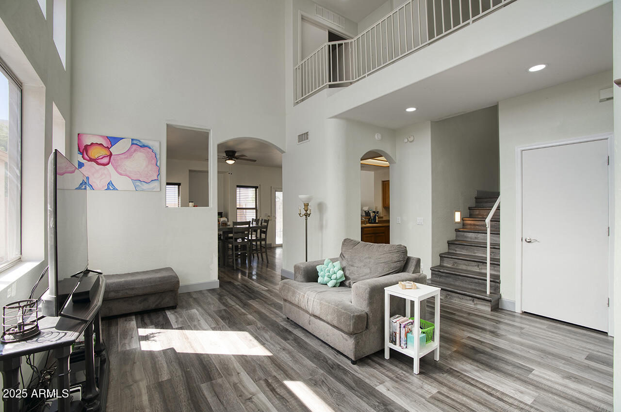 10617 West Coronado Road Avondale, AZ 85392 - Photo 3 of 32 a living room with furniture and wooden floor