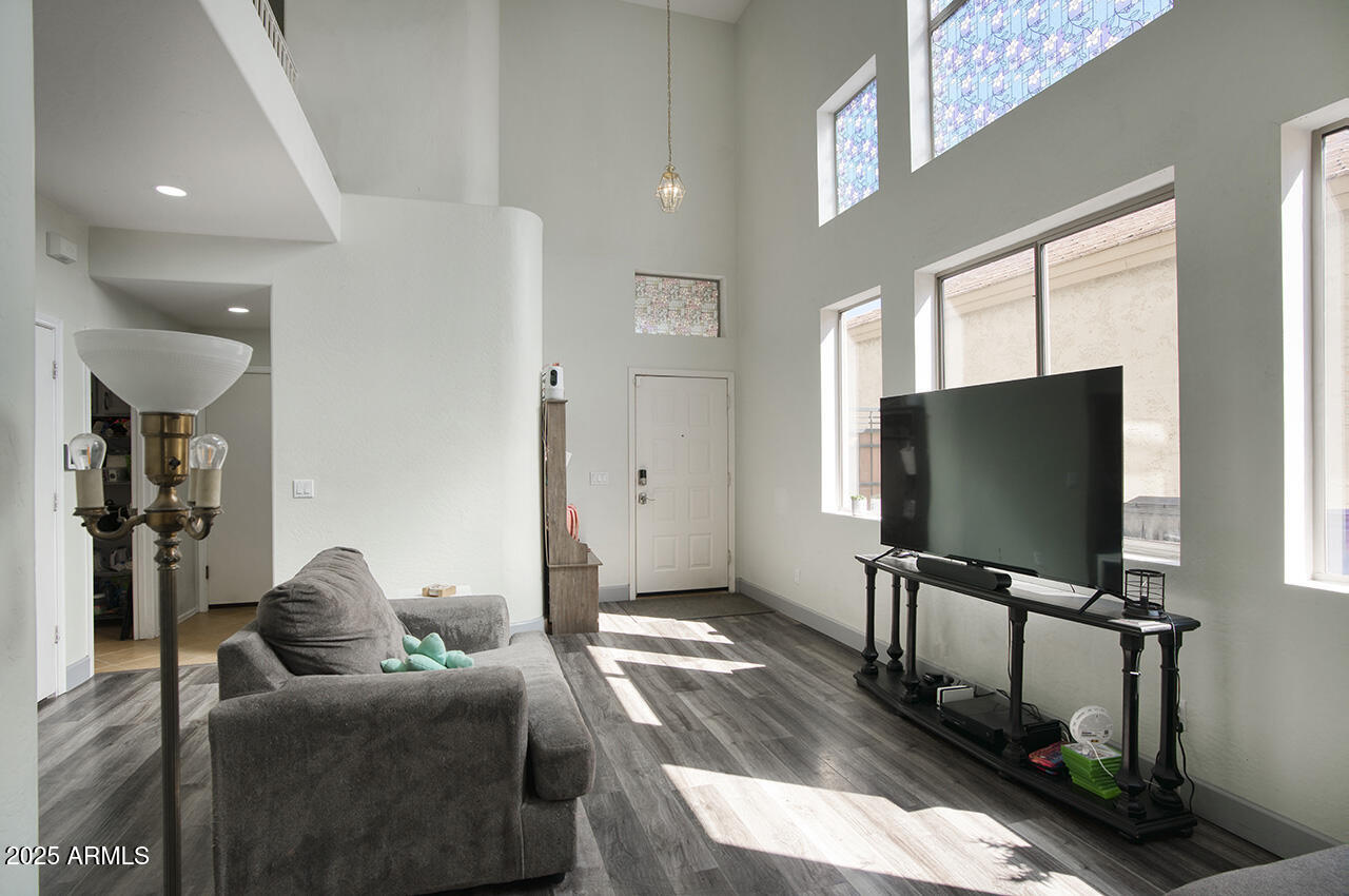 10617 West Coronado Road Avondale, AZ 85392 - Photo 5 of 32 a living room with furniture and a flat screen tv