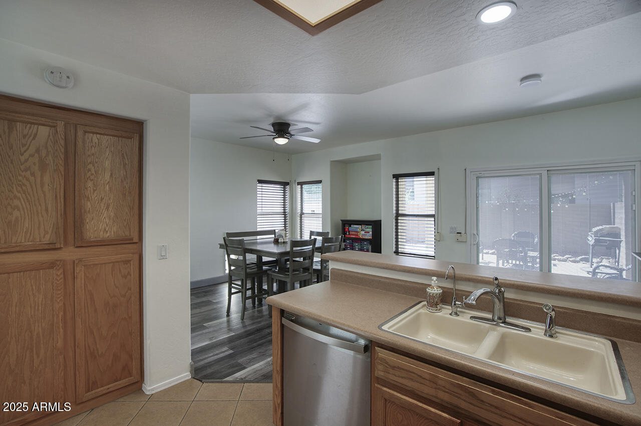 10617 West Coronado Road Avondale, AZ 85392 - Photo 7 of 32 a kitchen with a sink and chairs