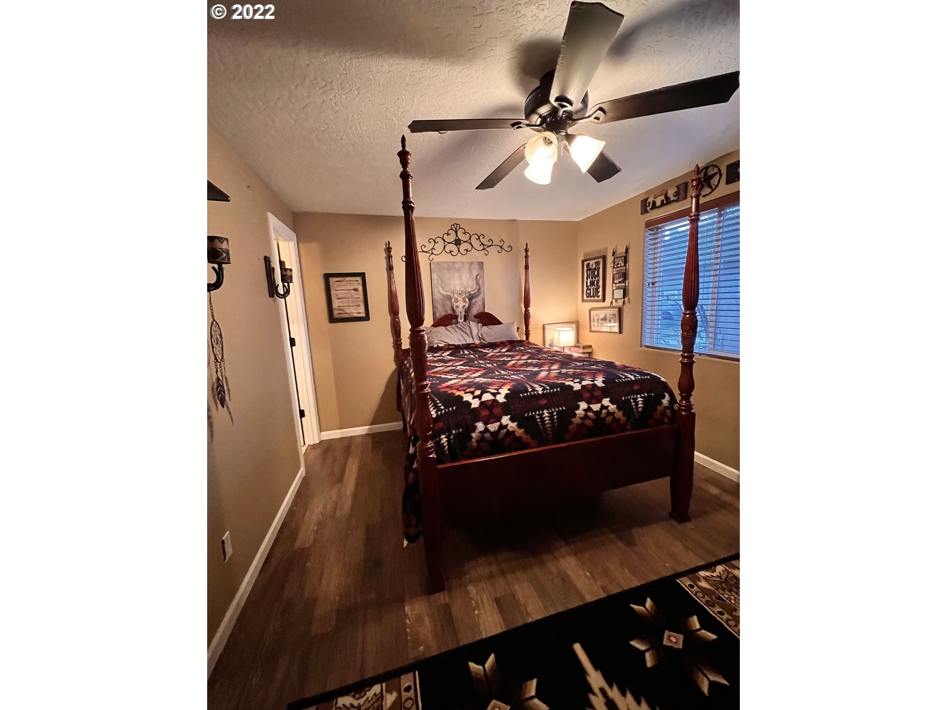 1654 South 59th Street Springfield, OR 97478 - Photo 9 of 15 a bedroom with a bed and a chandelier