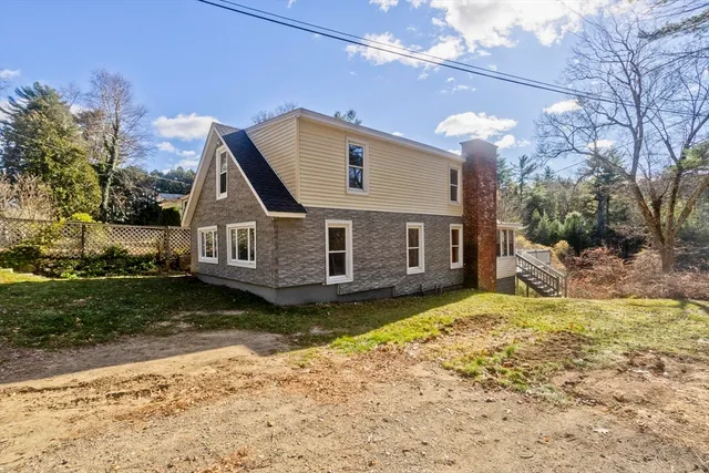a view of a house with a yard covered in snow