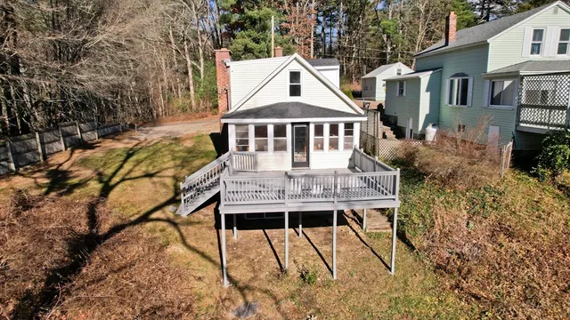 a view of a house with backyard and sitting area