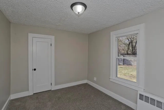 a porch with a bench next to a yard