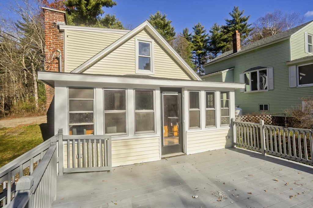 8 Summit Drive Palmer, MA 01069 - Photo 34 of 40 a porch with a bench next to a yard