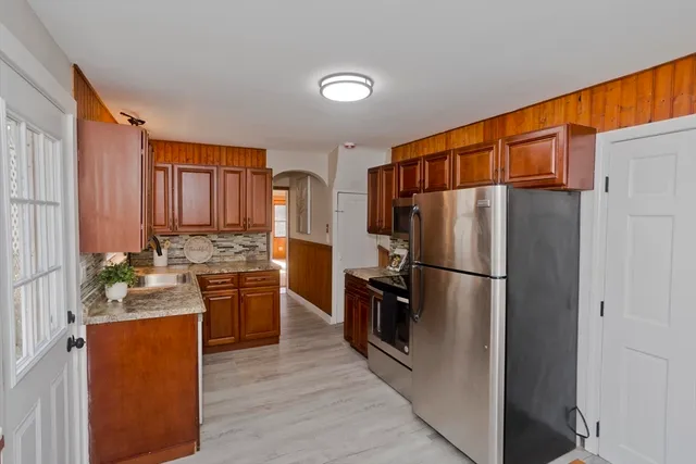 a kitchen with stainless steel appliances granite countertop a refrigerator stove and sink