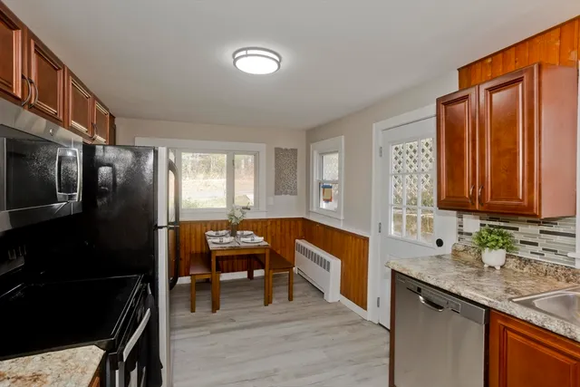 a kitchen with stainless steel appliances granite countertop a refrigerator and a sink