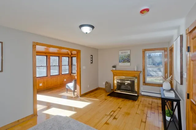 a view of an empty room with a fireplace and a window