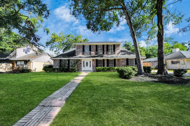 a front view of a house with a garden and porch