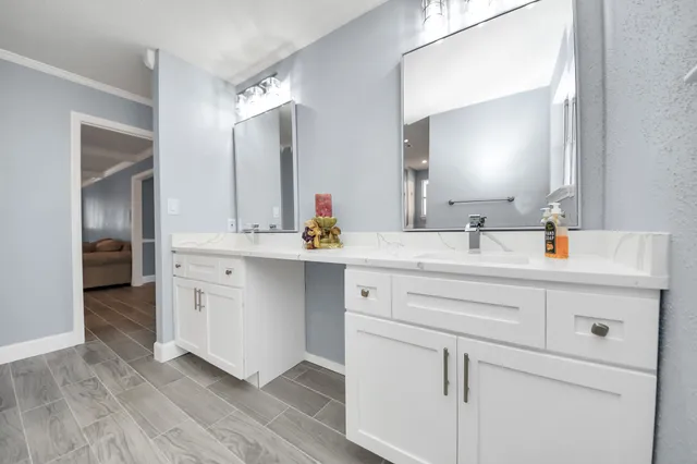 a bathroom with a double vanity sink mirror and