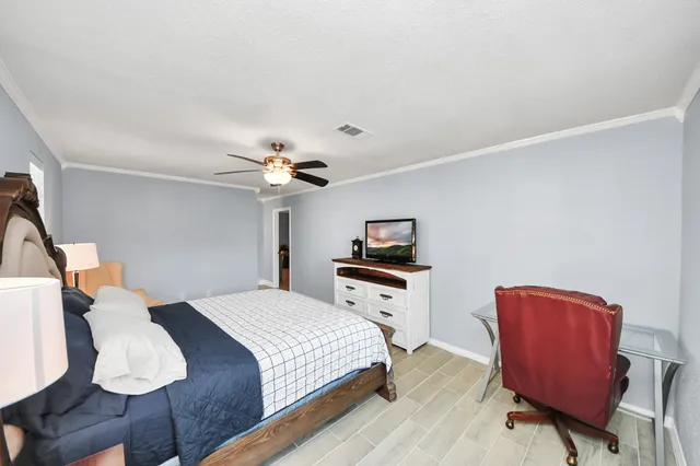 a bedroom with a bed and a chair in it