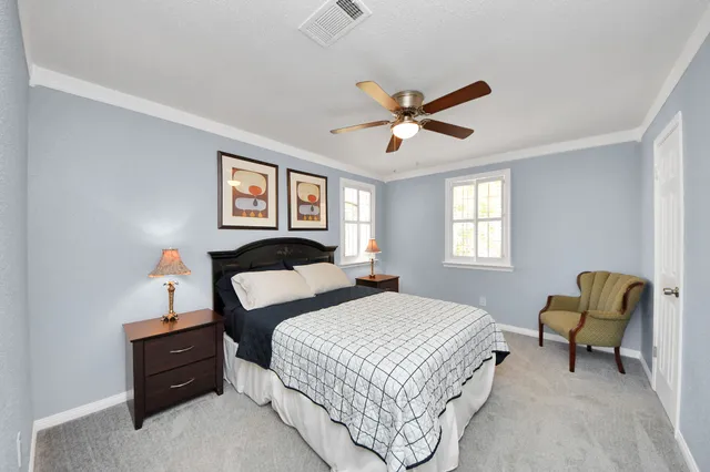 a bedroom with two beds and a window