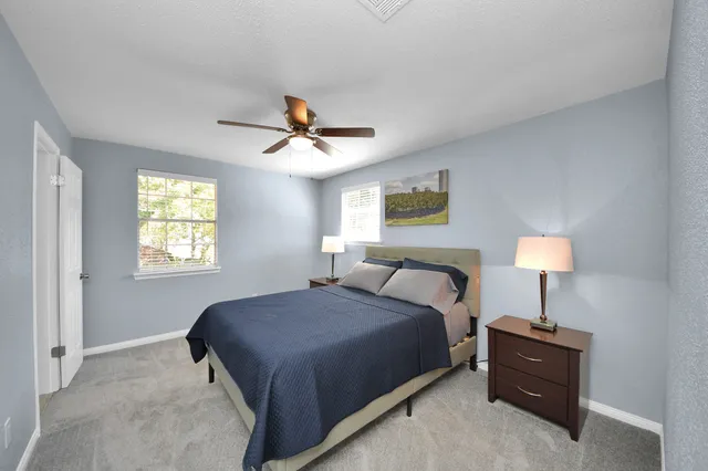 a bedroom with a bed and a lamp