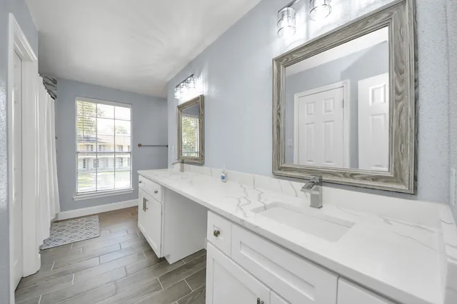 a bathroom with a sink double vanity and a mirror