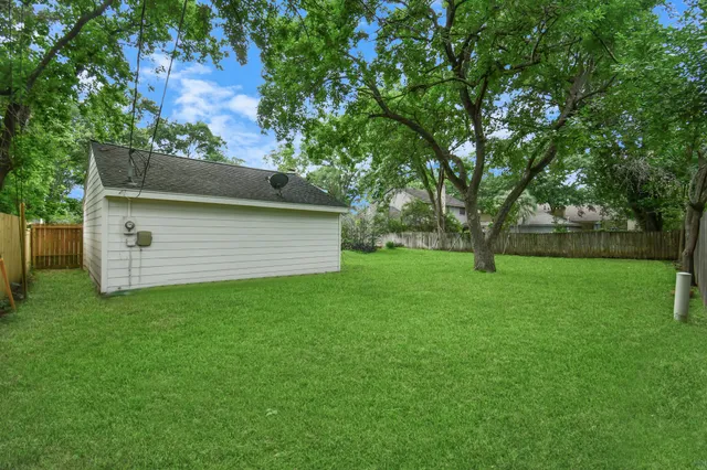 an aerial view of a house with a yard and garden