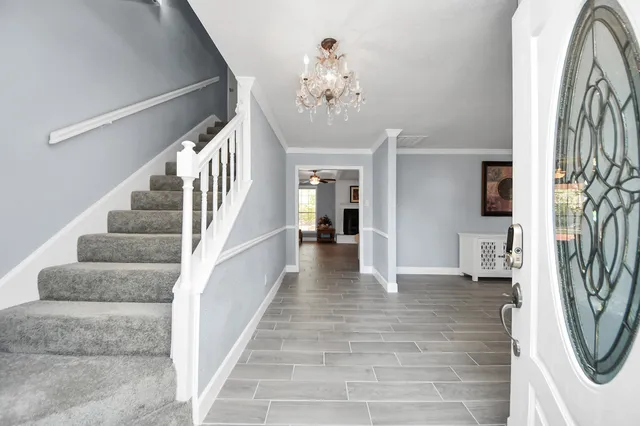 a view of entryway and hall with wooden floor