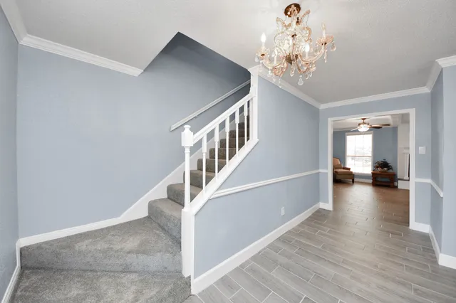 a view of entryway and hall with wooden floor