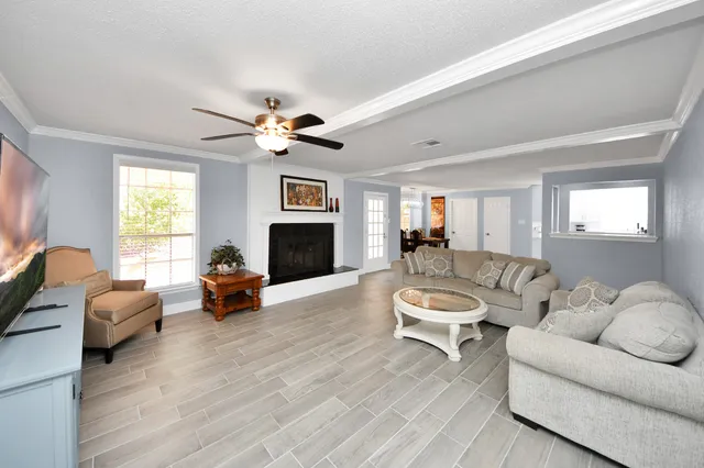 a living room with furniture fireplace and a window