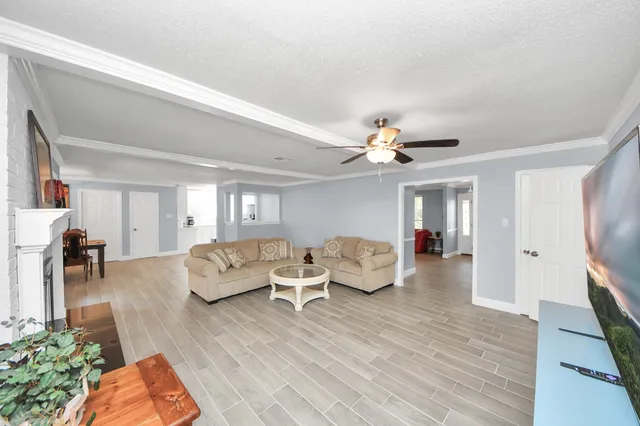 a living room with furniture and a chandelier