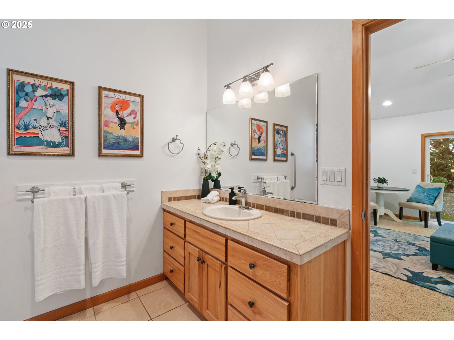 15014 Northeast Caples Road Brush Prairie, WA 98606 - Photo 17 of 39 a bathroom with a sink a mirror and a painting on the wall