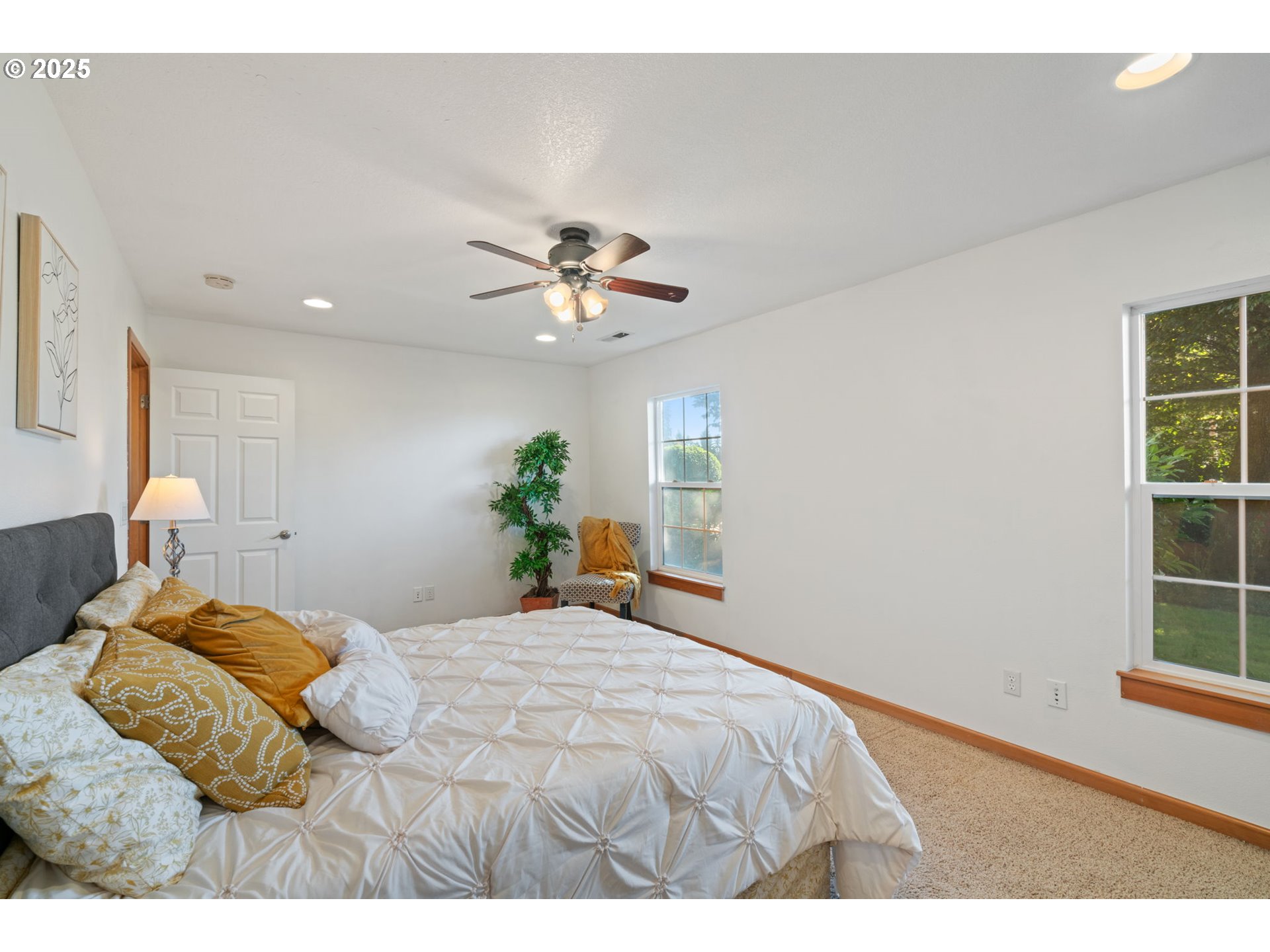 15014 Northeast Caples Road Brush Prairie, WA 98606 - Photo 20 of 39 a bedroom with a bed chandelier and a window